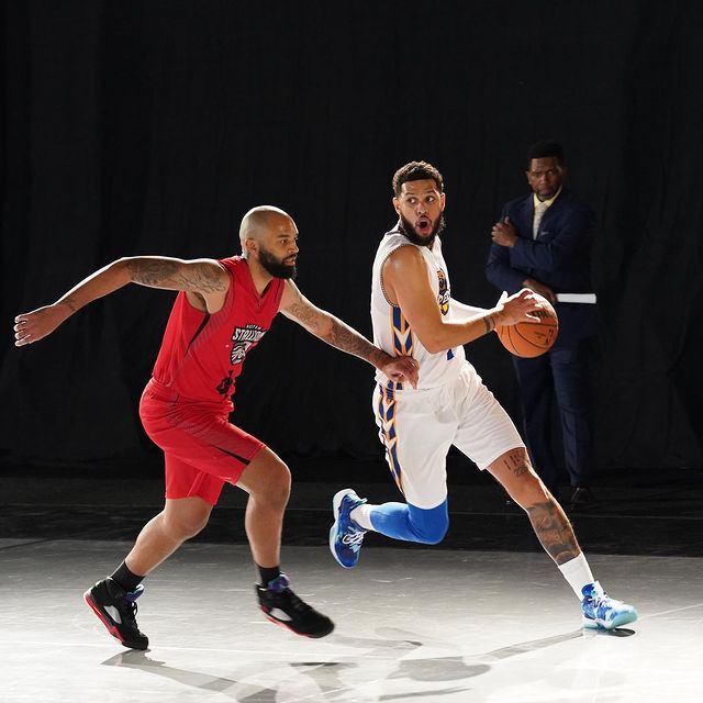 Sarunas J. Jackson in his basketball jersey playing basketball with his opponent.